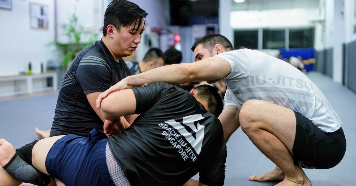 Instructor coaching students during a No-Gi Brazilian Jiu-Jitsu class at GJJ Singapore